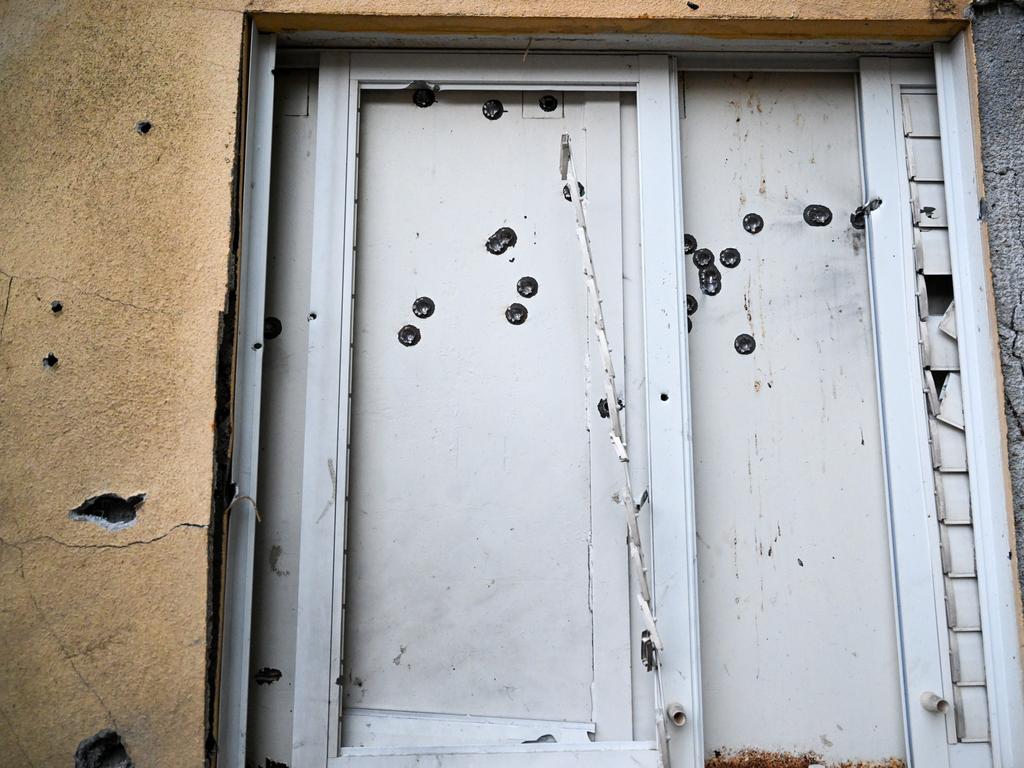 A safe room window in a house is covered with bullet holes where dozens of civilians were killed days earlier by Hamas militants.