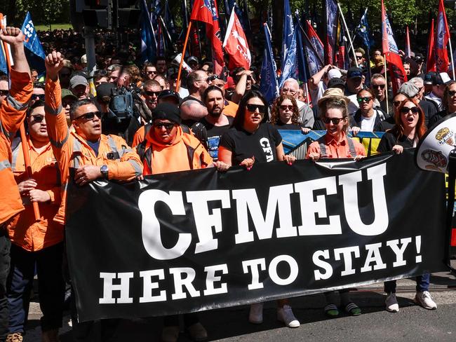 Protesters hold banners and chant slogans as they march in support of the Construction, Forestry and Maritime Employees Union (CFMEU) in central Sydney on September 18, 2024. Thousands of trade workers joined marches in Melbourne and Sydney to protest against the federal government's decision to force the CFMEU's construction arm into administration. (Photo by DAVID GRAY / AFP)