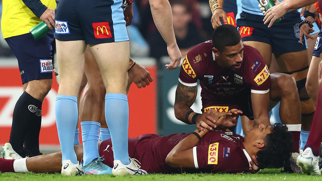 Dane Gagai assists Selwyn Cobbo after he was knocked out in the opening minutes of State of Origin III. Picture: Chris Hyde/Getty Images