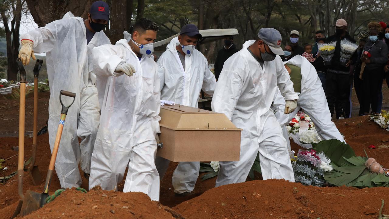 Cemetery workers in protective suits carry the coffin of a Covid-19 victim to be buried at a Sao Paulo cemetery last week. (Photo by Rodrigo Paiva/Getty Images)