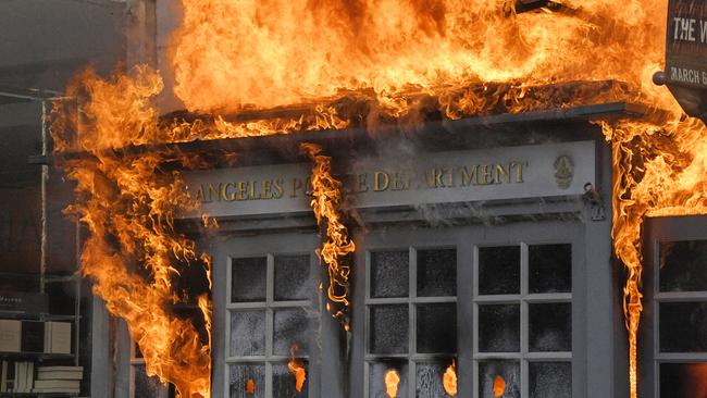 A Los Angeles Police Department kiosk is set ablaze in The Grove shopping centre during a protest over the death of George Floyd. Picture: AP