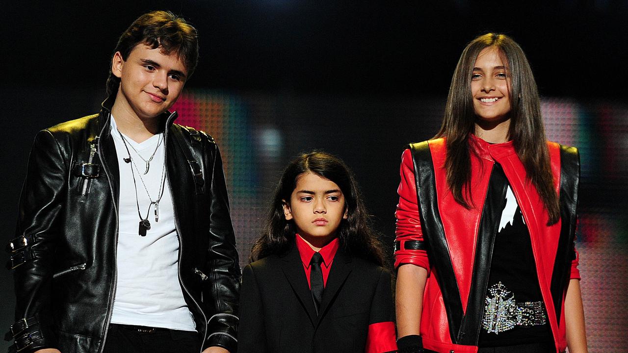 Michael Jackson's children Prince Jackson, Bigi and Paris Jackson on stage in LA during the Michael Forever concert in 2011. Picture: Leon Neal/AFP
