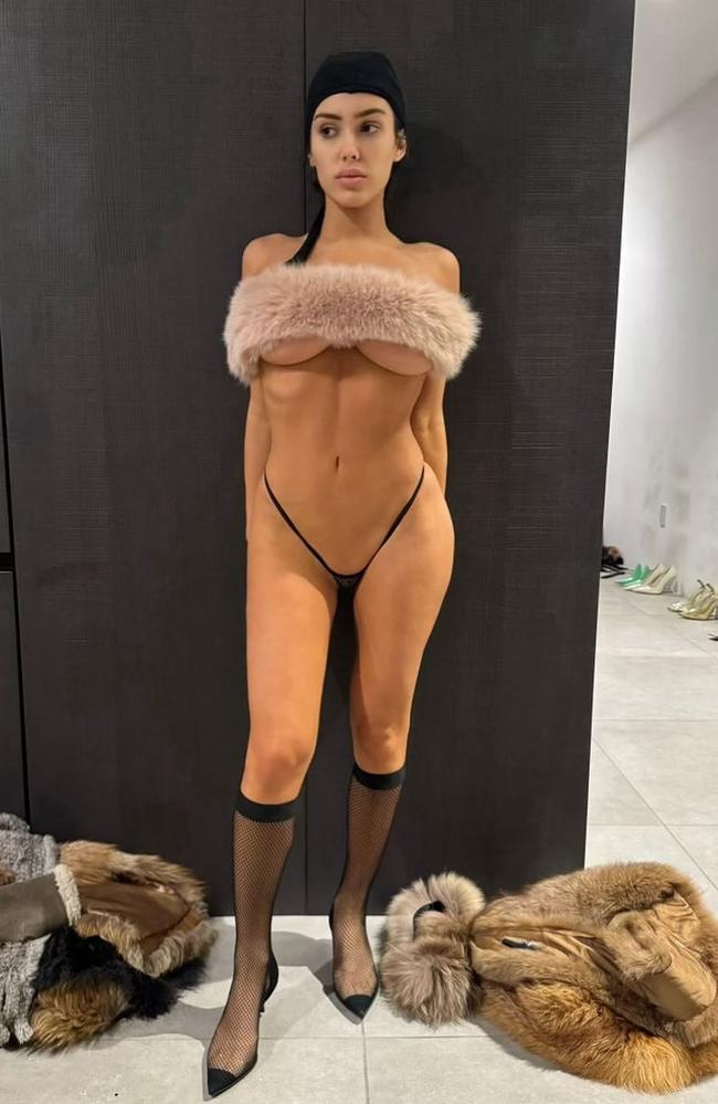 A fur stole and tiny G-string cover her modesty in this photo.