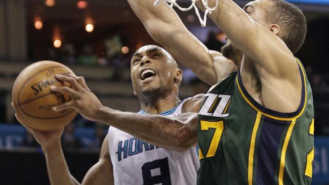 Charlotte Hornets' Gerald Henderson, left, drives against Utah Jazz's Rudy Gobert.