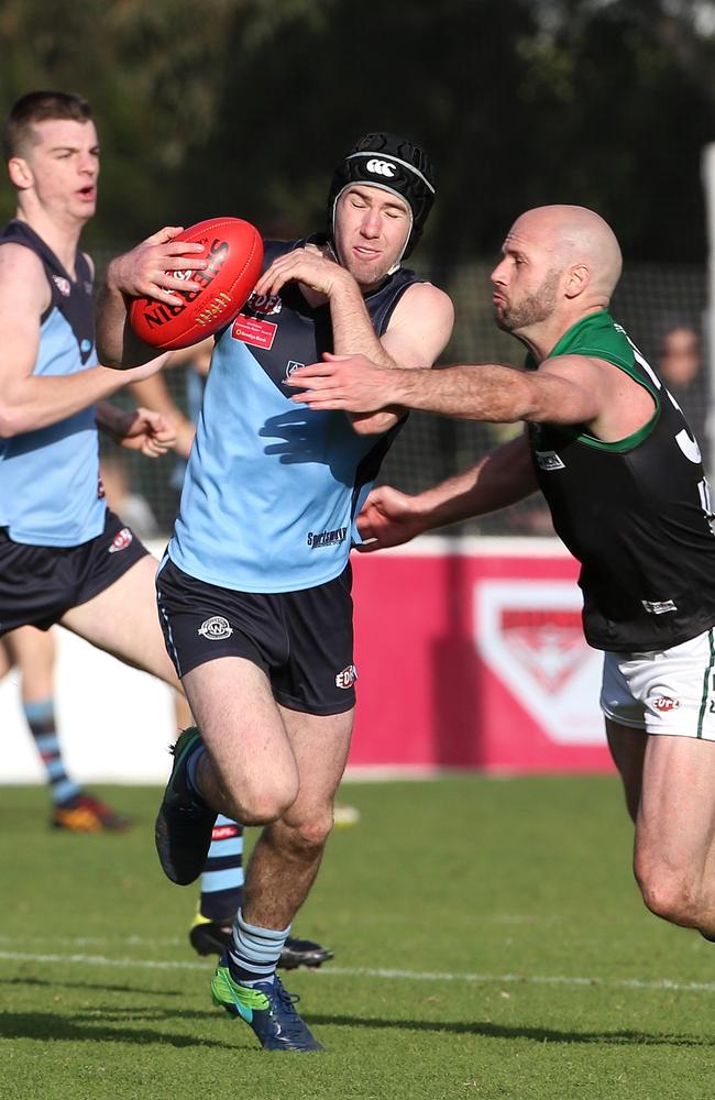 Zach Hislop of Aberfeldie is tackled by Paul Chapman of Greenvale during the EDFL grand final. Picture: Hamish Blair