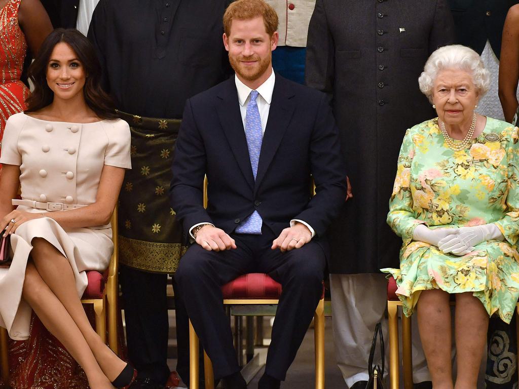 (L-R) Meghan, Duchess of Sussex, Britain's Prince Harry, Duke of Sussex and Britain's Queen Elizabeth II.