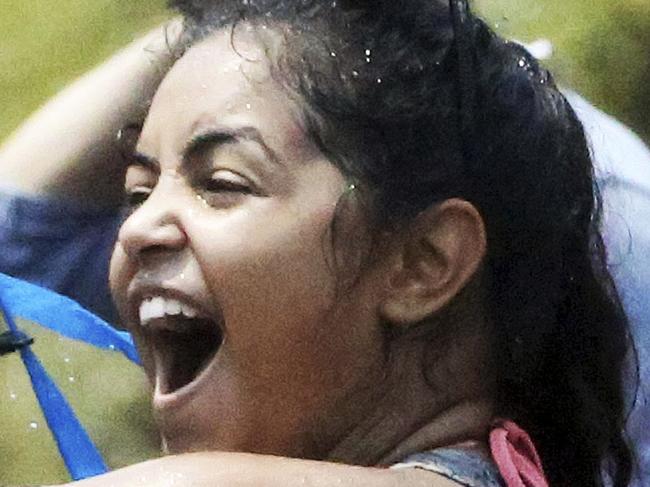 FILE - In this April 13, 2014 file photo, a foreign tourist holds a water gun as she takes part in a water fight during traditional Thai New Year celebrations or Songkran festival in Chiang Mai province, northern Thailand. Thailand’s military government is putting a dampener on the annual nationwide water fight. Despite Thailand’s worst drought in 20 years, the junta says it has no intention of limiting the virtually around-the-clock water throwing that defines the three-day Songkran festival. Instead, it has decided to impose morality measures.(AP Photo/Apichart Weerawong, File)