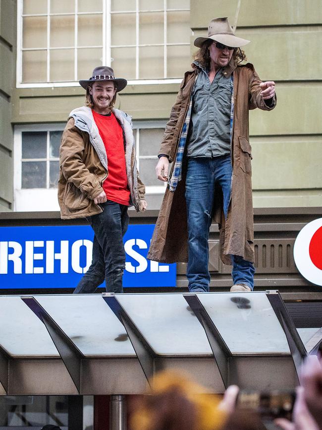 Protesters on a tram stop roof. Picture: Mark Stewart