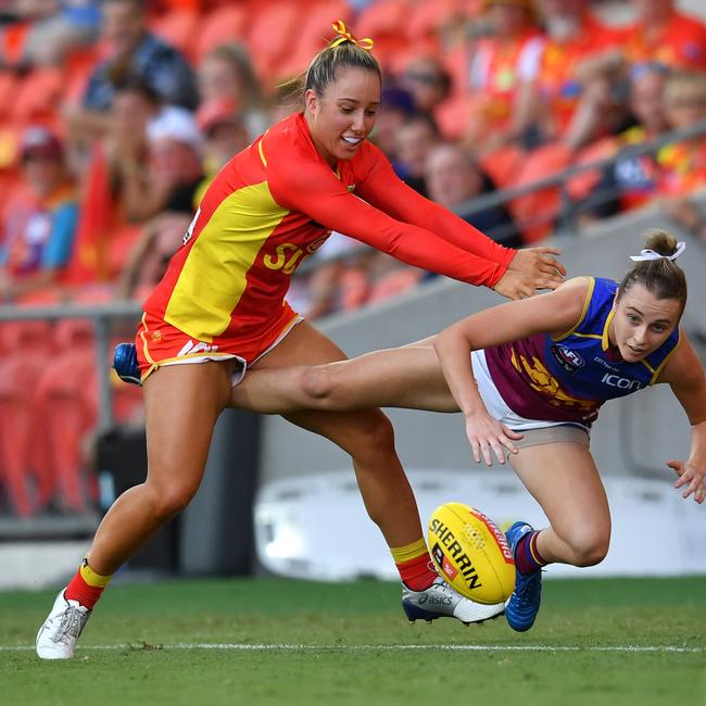 Jacqui Yorston (left) of the Suns tackles Gabby Collingwood (right) of the Lions during the Round 3 AFLW match between the Gold Coast Suns and Brisbane Lions at Metricon Stadium on the Gold Coast, Saturday, February 22, 2020 (AAP Image/Darren England)