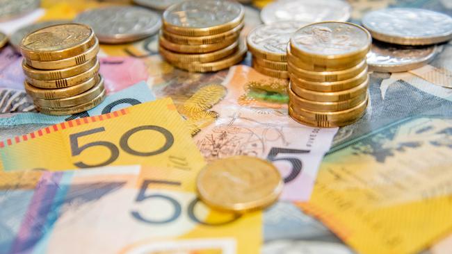 Australian notes and coins spilled out on a table, money cash generic