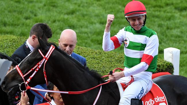 Jockey Damian Lane (centre) after riding Lys Gracieux to Victory in race 9, the Ladbrokes Cox Plate. Picture: (AAP Image/James Ross