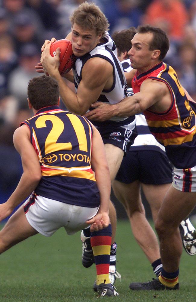 Cat Will Slade is tackled by Tyson Edwards and James Gallagher during Adelaide’s last win at Kardinia Park in 2003.