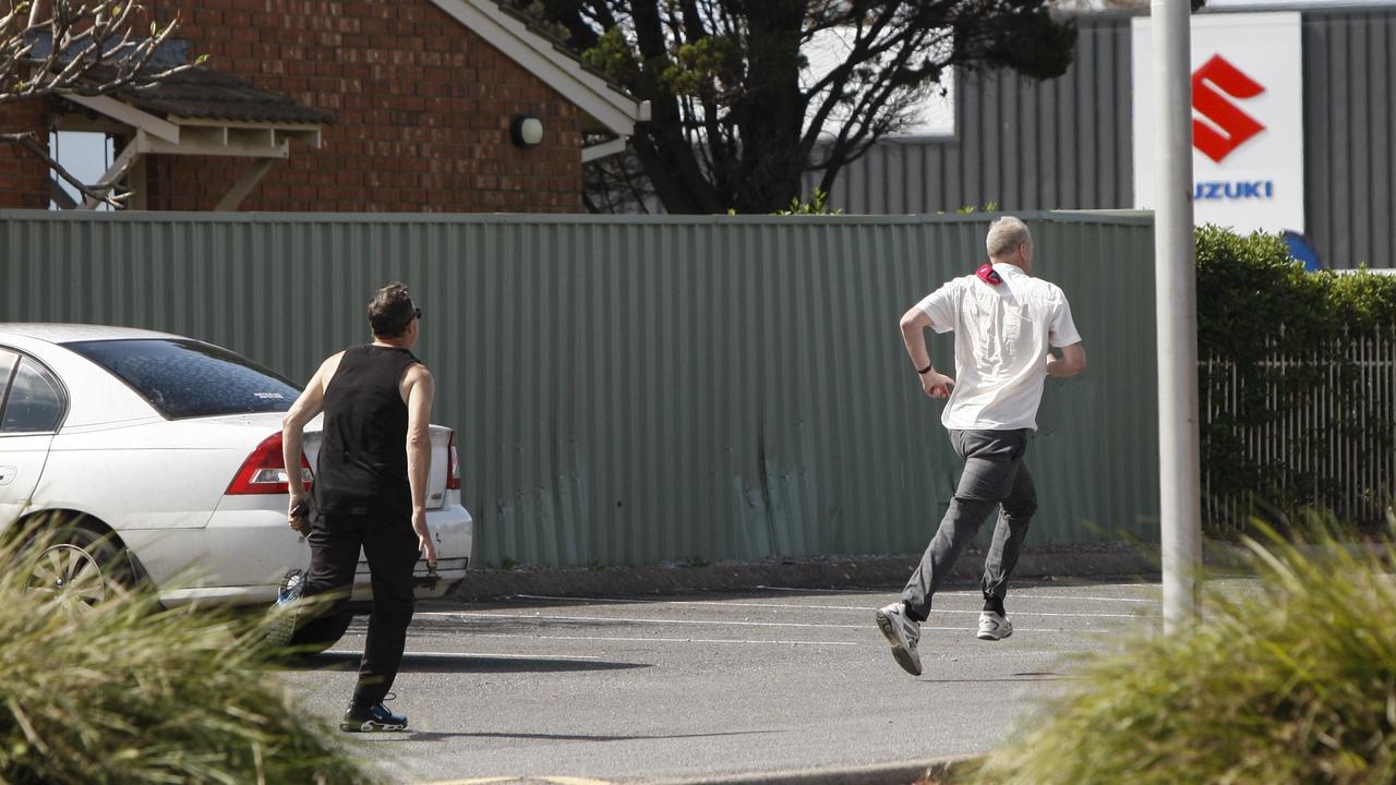 The ex-councillor flees Christies Beach Magistrates Court, chased by the man. Picture: Brett Hartwig