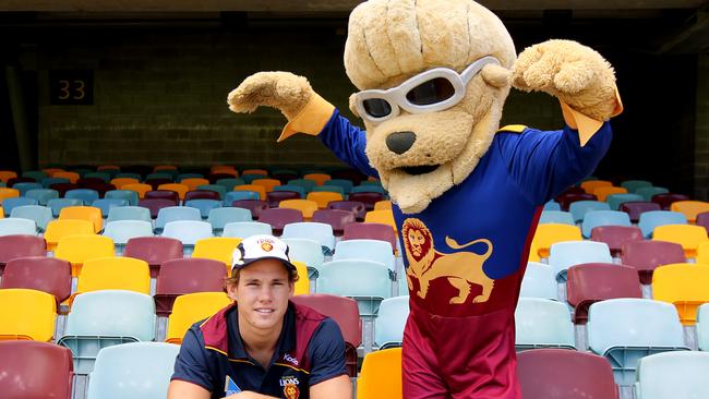 Brisbane Lions player Jack Redden with their mascot 'Bernie Gabba Vegas'. The team were once known as the Gorrillas.