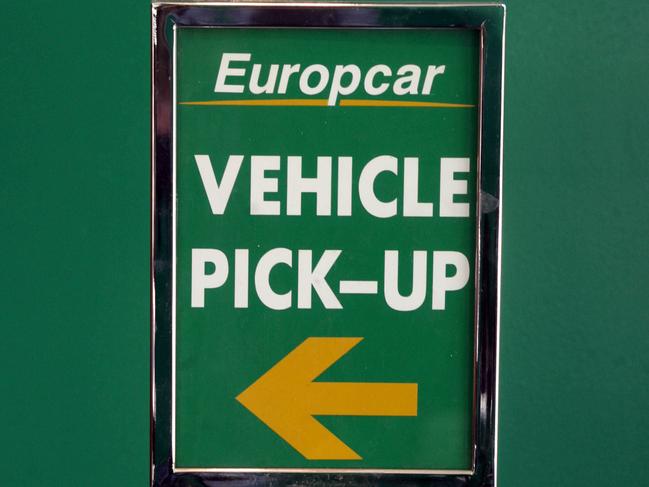 Europcar pick-up & vehicle return signs at local franchise of car rental film, in Melbourne.