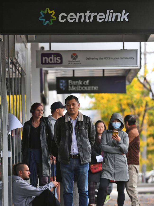 People queue up outside a Centrelink office in Melbourne.