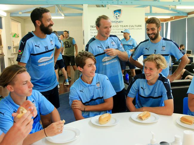 Sydney FC players Alex Brosque, Rhyan Grant and Michael Zullo mixing with members of the under 18's squad as part of a bonding session after training at Macquarie Park. pic Mark Evans