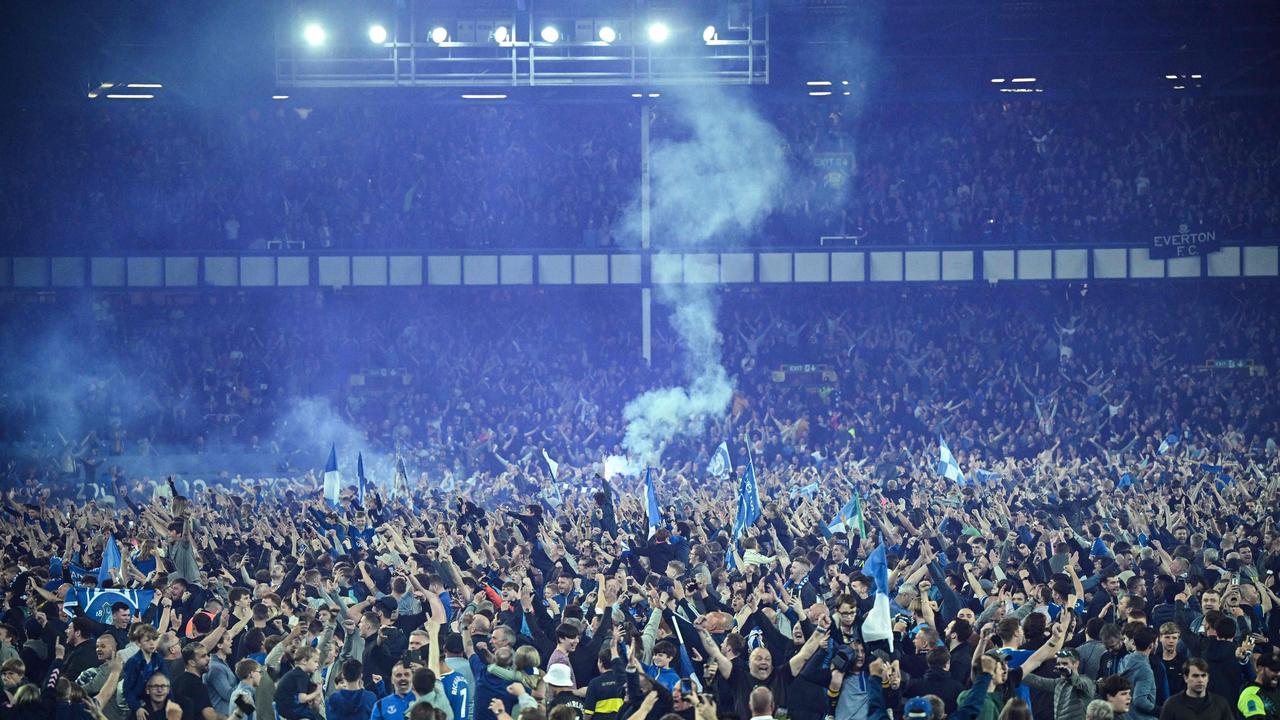 Everton's fans invade the football pitch. Photo by Oli SCARFF / AFP.