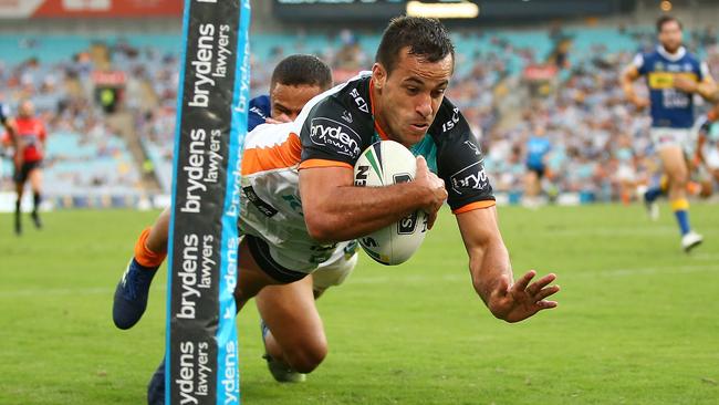 SYDNEY, AUSTRALIA — APRIL 02: Corey Thompson of the Tigers dives to score during the round four NRL match between the Wests Tigers and the Parramatta Eels at ANZ Stadium on April 2, 2018 in Sydney, Australia. (Photo by Mark Nolan/Getty Images)