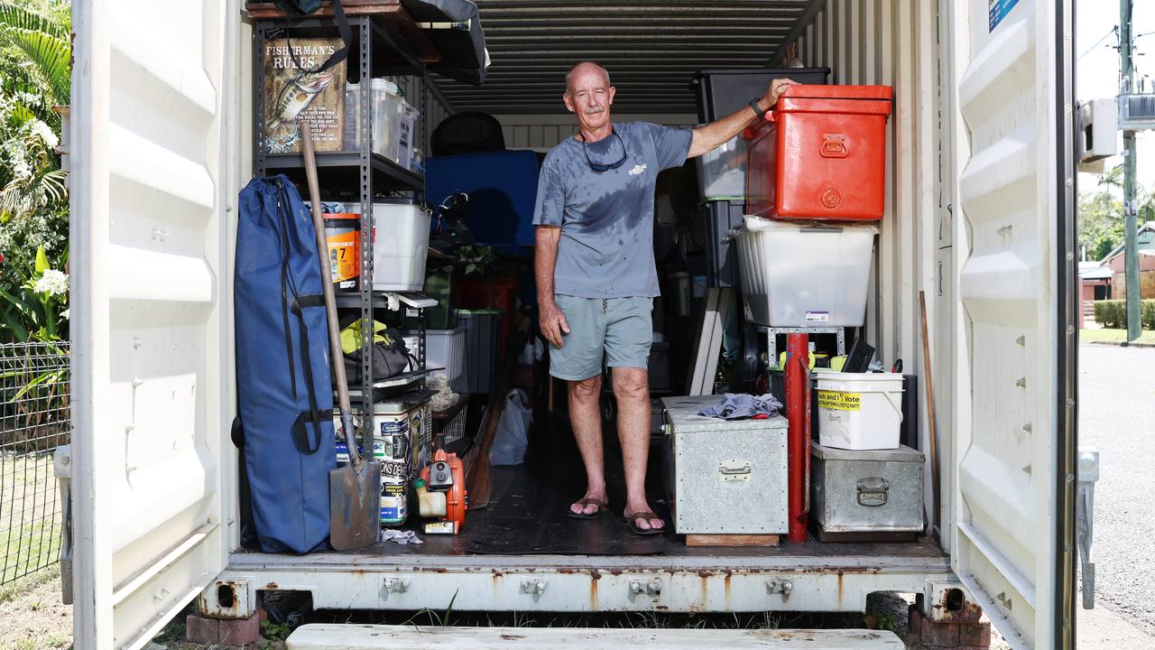 After having their Holloways Beach house badly damaged in last year's flood, Chris Tress and his wife have made the decision to demolish the existing structure and build a new, smaller kit home on the existing slab. The couple hope to have their new home completed by June. Chris Tress has had most of his possessions locked up in a storage container at the front of his property. Picture: Brendan Radke