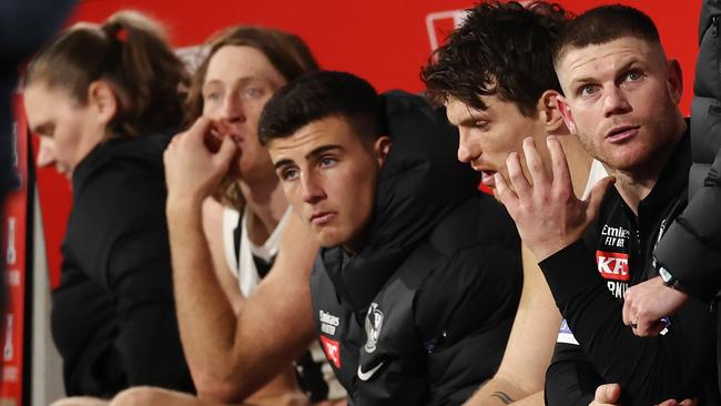 MELBOURNE, AUSTRALIA – August 5, 2023. AFL. Injured Pies Taylor Adams, Brody Mihocek, Nick Daicos, Nathan Murphy and Tom Mitchell back row on the bench last qtr during the round 21 match between the Hawthorn and Collingwood at Marvel Stadium in Melbourne. Photo by Michael Klein.