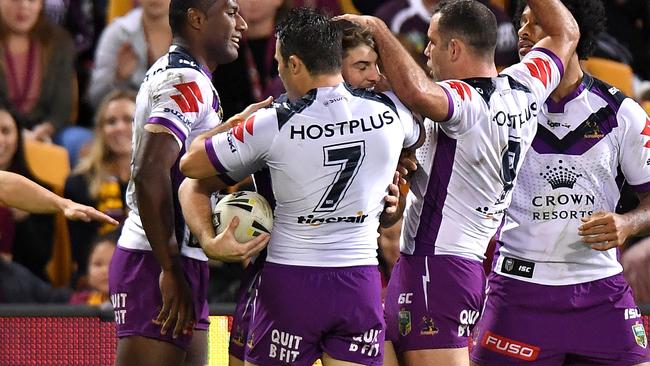 Curtis Scott celebrates a try with Storm teammates.