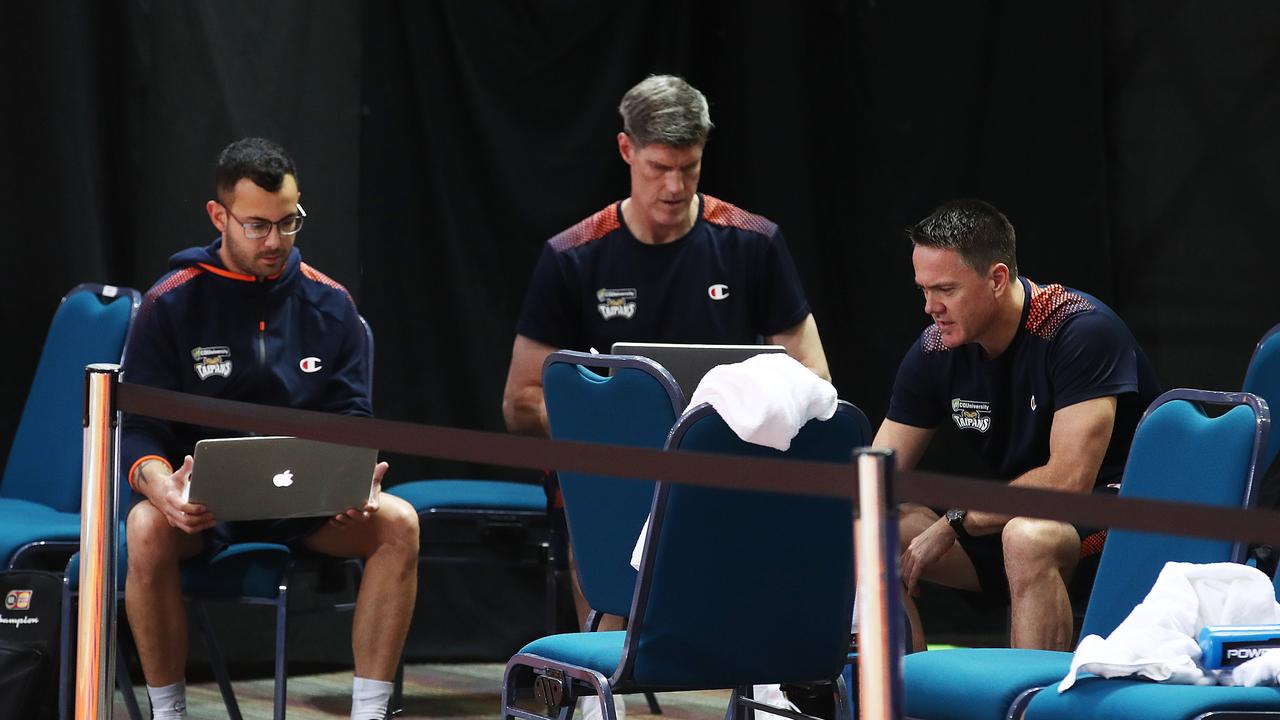 Cairns Taipans intern Lennon Smartt, head coach Mike Kelly and lead assistant coach Jamie O'Loughlin at the conclusion of Taipans training. Picture: Brendan Radke