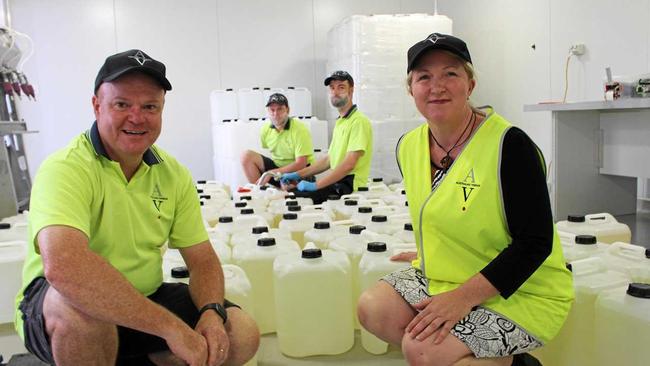 HELPING OUT: Ian Henderson and Josie Howard and (back) vinegar makers Michael Britten and Joerg Achenbach with just some of the bottles sent to Townsville. Picture: Liana Walker