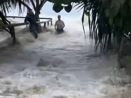 A video posted to TikTok on Wednesday shows a wave of water surging up a beach path at Currumbin Alley and into the carpark.