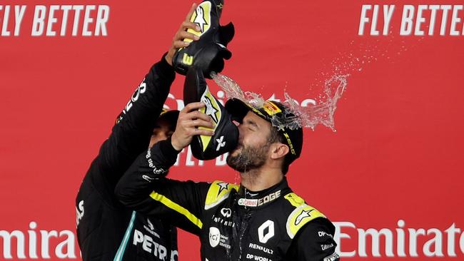 Lewis Hamilton spills champagne from his shoe over third placed Daniel Ricciardo