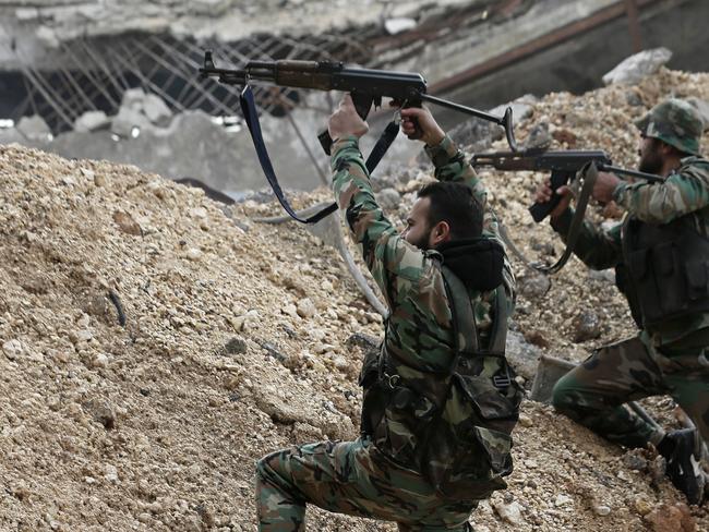 Syrian army soldiers fire their weapons during a battle with rebel fighters at the Ramouseh front line, east of Aleppo, Syria, Monday, Dec. 5, 2016. The government seized large swaths of the Aleppo enclave under rebel control since 2012 in the offensive that began last week. The fighting was most intense Monday near the dividing line between east and west Aleppo as government and allied troops push their way from the eastern flank, reaching within less than a kilometer (half a mile) from the citadel that anchors the center of the city. (AP Photo/Hassan Ammar)