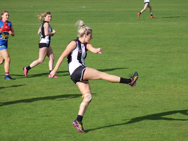 Claremont's Natalie Smedley gets a kick away during the match against Huonville in the SFLW Premiership League. Picture: Jake Garland