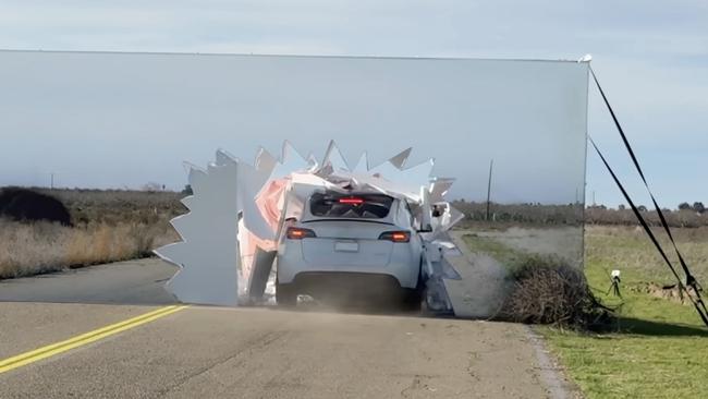 The Tesla smashed through a wall with a picture of a road. Picture: YouTube/Mark Rober