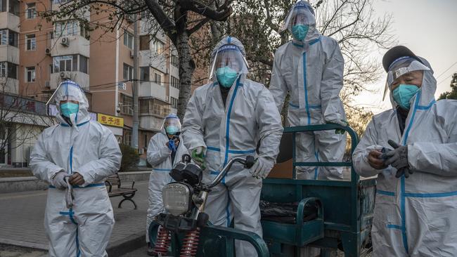 Epidemic control workers remove medical waste from home quarantine facilities in Beijing, as concerns rise over China’s outbreak. Picture: Kevin Frayer/Getty Images