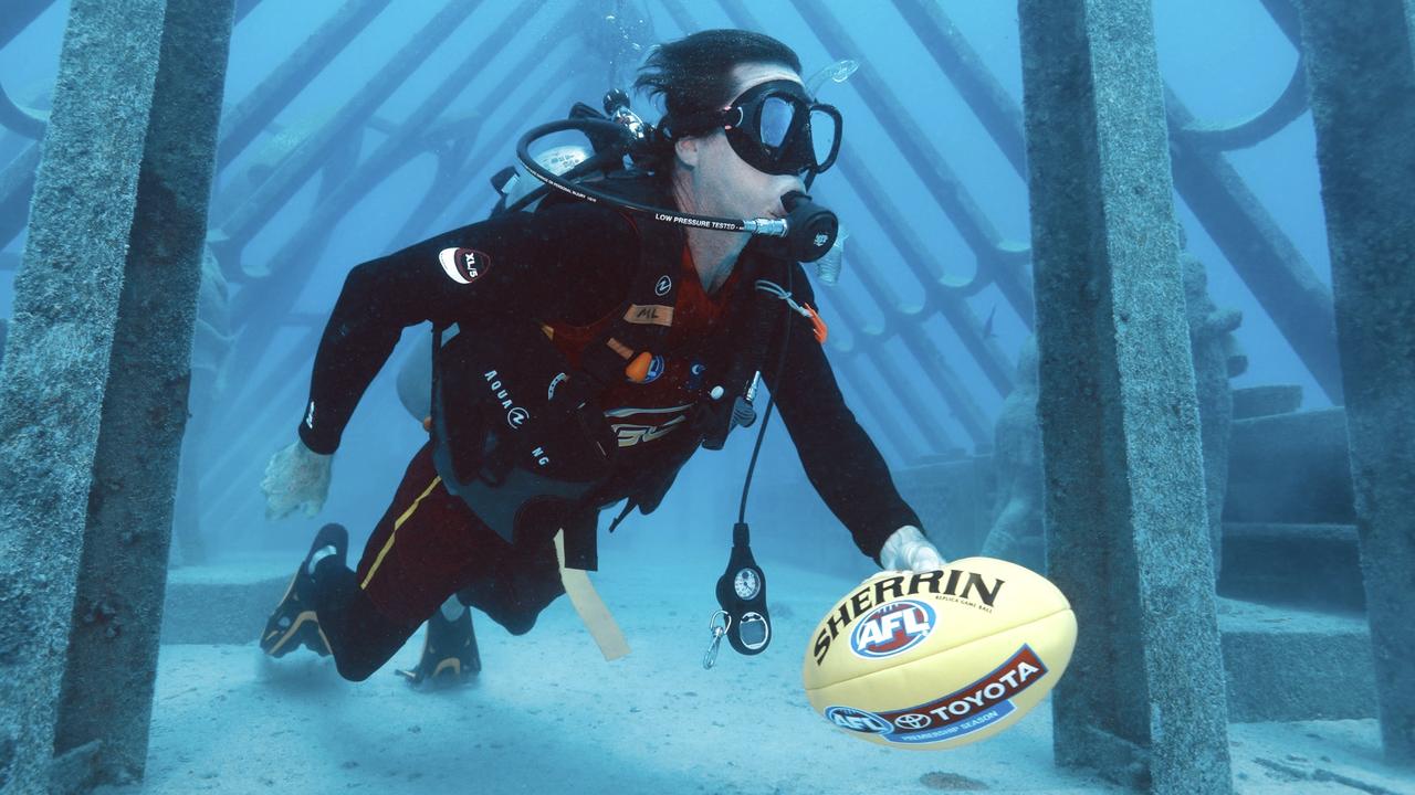 Ashley Ogden underwater with a Sherrin. Picture: Brooke Miles Ogden