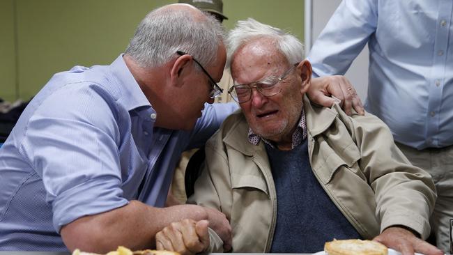 Prime Minister Scott Morrison comforts 85-year-old Owen Whalan, who was twice evacuated from his Koorainghat home due to bushfires last year. Picture: AAP