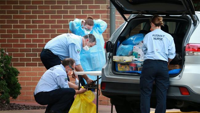 AUSMAT personnel gather outside Doutta Galla Aged Services. Picture: Sarah Matray