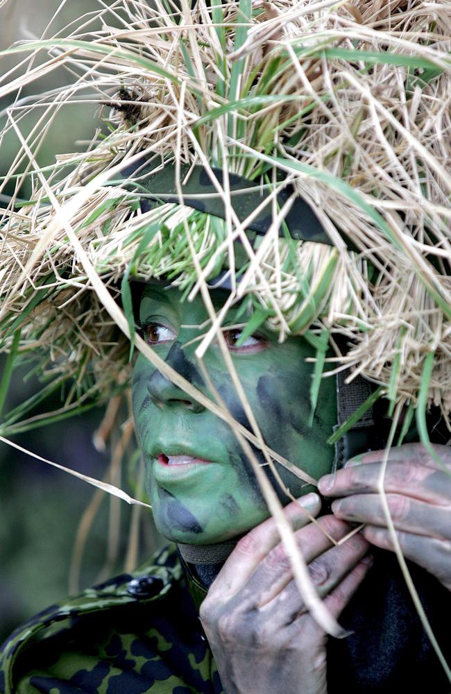 Princess Mary in uniform puts on a helmet during an exercise of the Danish Home Guard. Picture: Home Guard Command/EPA