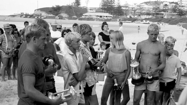 At the 1965 Qld State titles in Coolangatta (LtR) Bob McTavish, Harry “Hacka” Allen, Graham Black, Phyliss O’Donnell, Carol Charlton, Peter Drouyn, Peter Lascelles Picture: Supplied by Mal Sutherland