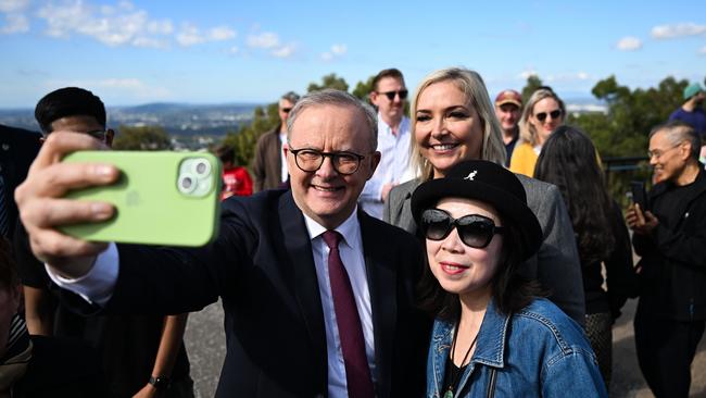 Anthony Albanese takes a selfie with Labor candidate Rebecca Hack, rear, and a supporter in Brisbane on Thursday. Picture: Dan Peled / NewsWire