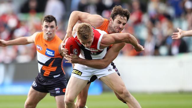 Jeremy Finlayson tackles St Kilda’s Seb Ross. Picture: Getty Images