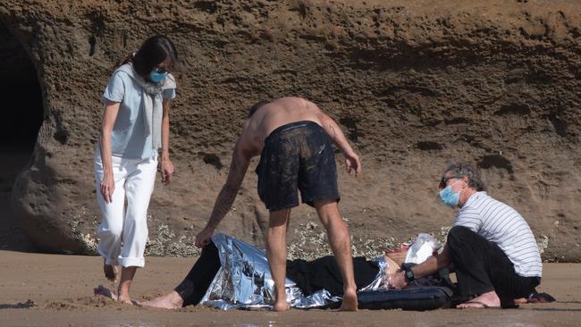 Man rescued after hitting head on reef at Bird Rock, Jan Juc. Locals and paramedics worked together to treat and move the man, using a resident's ute. Pictures: Shaun Viljoen