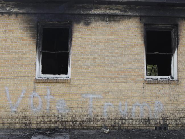 Graffiti spray-painted on a predominantly black Baptist church in Mississippi after an arson attack last week. Picture: Rogelio V. Solis/AP