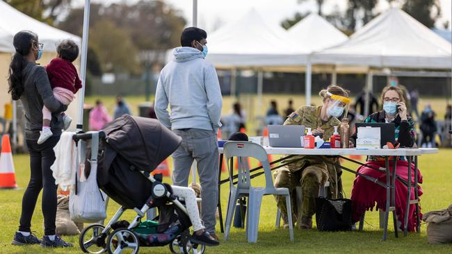 Private Claudia Gould, second right, assists a NSW Health worker at the Dubbo Mass Vaccination centre. Picture: ADF