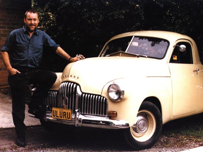 Singer John Williamson with his beloved FJ Holden ute with number plate "Uluru" pictured in 1999. Picture: Supplied