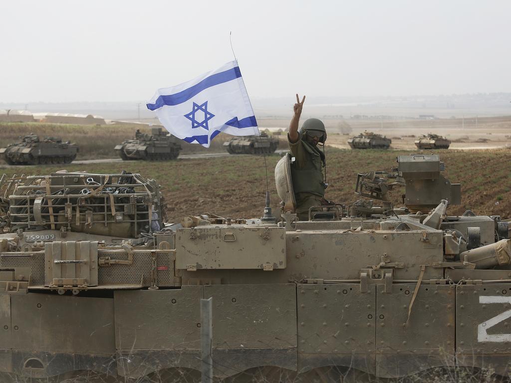 A soldier atop a tank near the border with Gaza. Israel has sealed off Gaza and launched sustained retaliatory air strikes, which have killed at least 1,400 people. Picture: Amir Levy/Getty Images