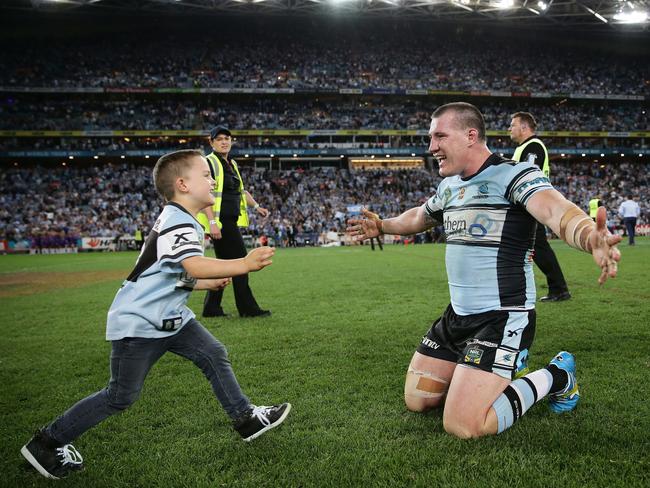 Son Kody runs into the arms of hero dad after the game at ANZ Stadium, Sydney. Picture: Brett Costello