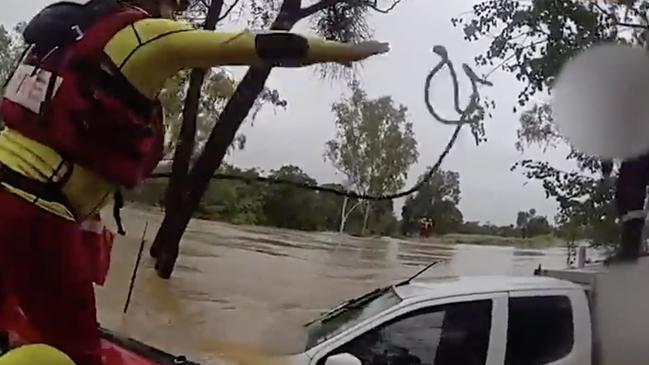 Swift water rescue crews rescued a driver stranded on his ute's roof after his vehicle was swept of the roadway at Balyendo crossing. Image: QFD