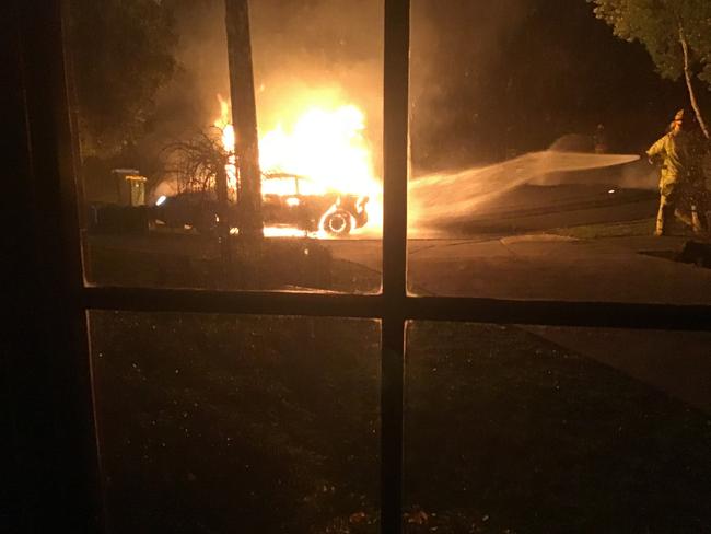 The white Toyota Celica on fire in Kenross Court, Wantirna South.