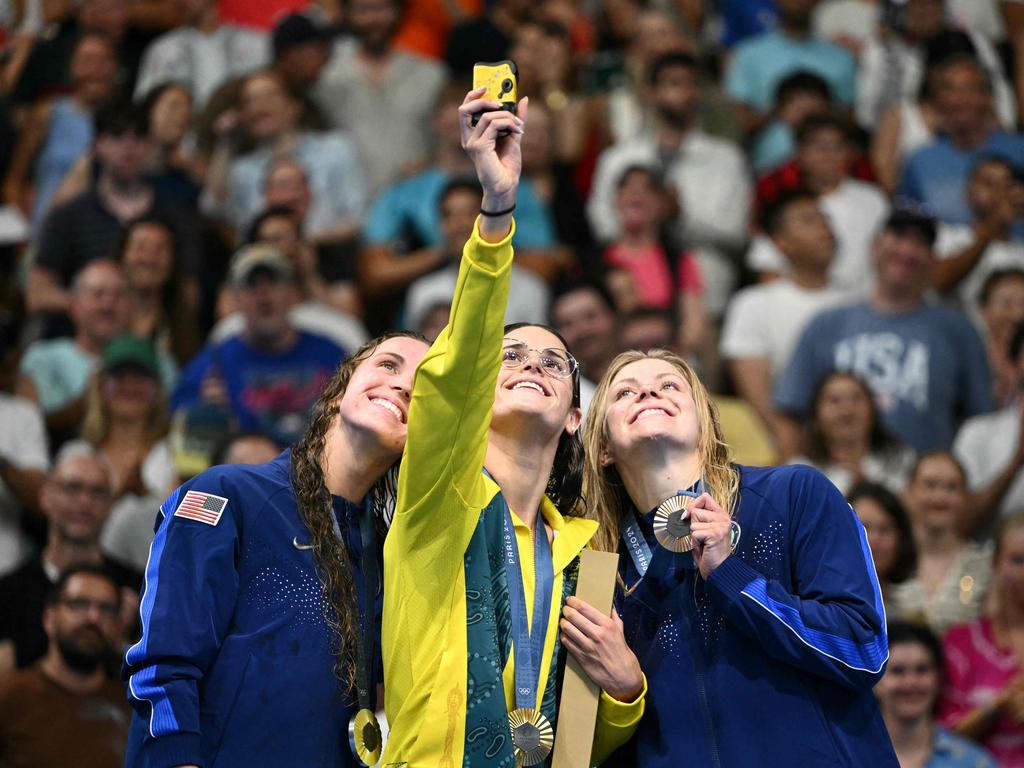 Silver medallist USA’s Regan Smith, left, gold medallist Australia's Kaylee McKeown, centre, and bronze medallist USA’s Katharine Berkoff take a selfie with their medals on the podium. The obvious camaraderie between rival teams is always one of the highlights of the Games. Picture: Sebastien Bozon/AFP